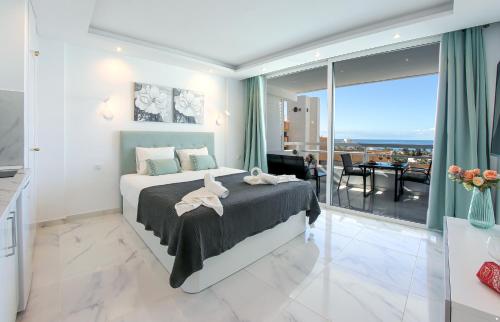 a bedroom with a bed with a view of the ocean at SEA LA VIE Ponderosa 617 in Playa Fañabe