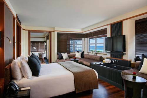 a hotel room with a large bed and a television at The Setai, Miami Beach in Miami Beach