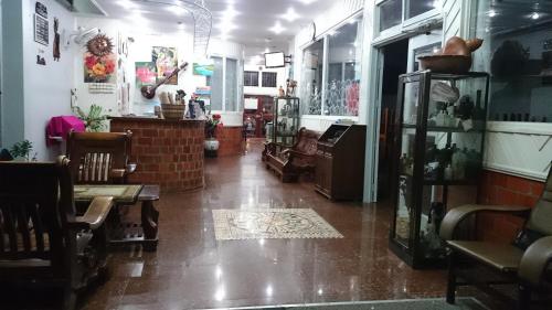 a room with chairs and tables in a store at Hotel Paramuru in Paramaribo