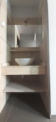 a bathroom with a sink and a mirror at Departamentos corazón in San Rafael