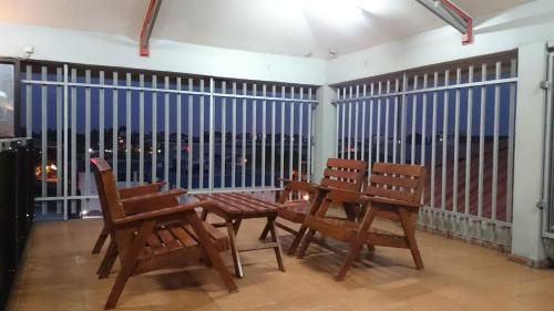 a room with two chairs and a table and a window at Hotel Paramuru in Paramaribo