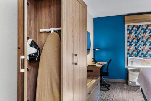 a room with a door to a bedroom with a desk at Holiday Inn Express New Albany by IHG in New Albany
