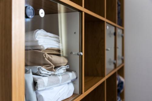 a glass cabinet filled with towels and towels at Entire luxurious flat sleeps 4 persons in London