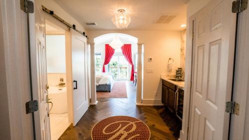 a hallway leading to a bedroom with a bed at Regatta Inn - Adults Only in Folly Beach