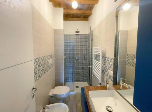 a bathroom with a sink and a toilet and a shower at Dimora il Fontanile in Castel di Guido