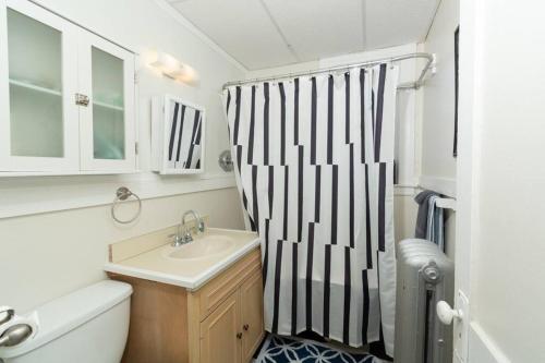 a bathroom with a black and white shower curtain at The Elizabeth Suite B2 in Hartford