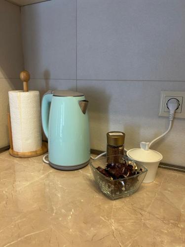 a tea kettle and a bowl of food on a counter at Bakuriani Hotel Apartments 301 in Bakuriani
