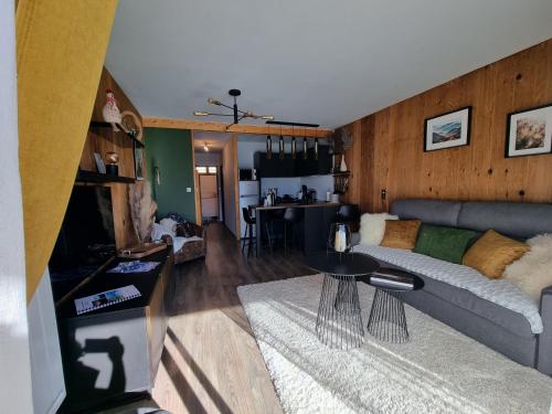 a living room with a couch and a table at STUDIO - ROCHES ROUSSES b in Orcières