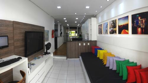 a room with colorful chairs and a television at Albergaria Hostel in Fortaleza