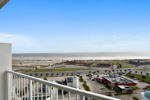 a view of the beach from the balcony of a condo at Emerald 1111 in Galveston