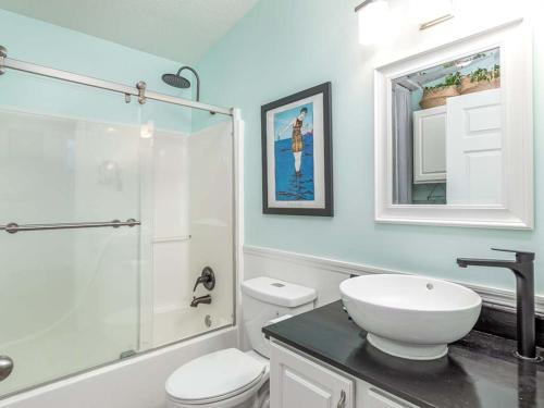 a bathroom with a sink and a toilet and a shower at Laurel Reef in Tybee Island