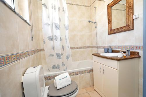 a bathroom with a toilet and a sink and a tub at K - ViewPoint of Lagos GuestHouse in Lagos