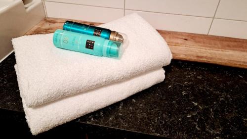 a bottle of water sitting on top of a towel at comfortable chalet in a unique location in forest in Essen