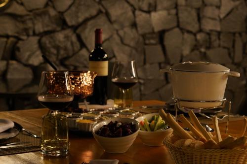 a table topped with wine glasses and bowls of food at Sanma Hotel in Foz do Iguaçu