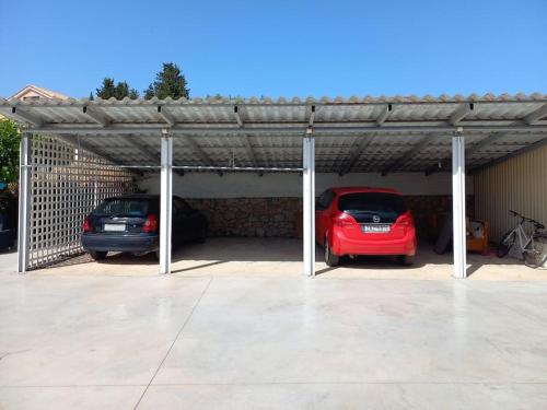 a car garage with two cars parked in it at Agios Leon Apartment 2 in Agios Leon