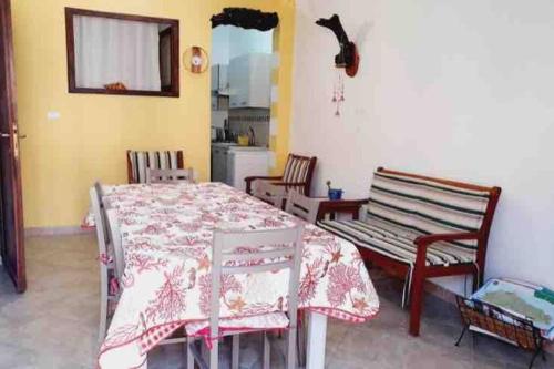 Zimmer mit einem Tisch, 2 Stühlen, einem Tisch und einem Tisch in der Unterkunft Sant Antioco, la vista sulla laguna Q2127 in SantʼAntìoco