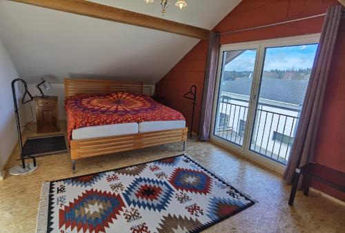 a bedroom with a bed and a balcony at Haus Waldeck in Ühlingen-Birkendorf