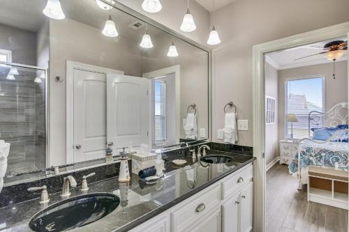uma casa de banho com 2 lavatórios e um espelho grande em Enchanted Beachfront by Ryson Vacation Rentals em Galveston