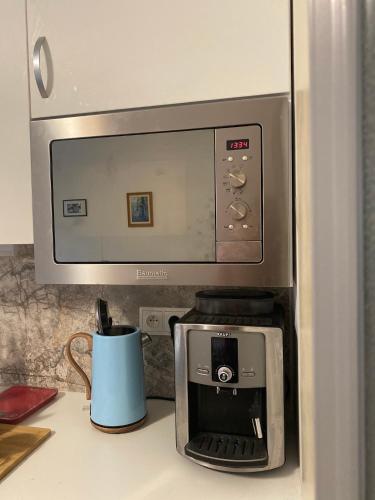 a microwave oven sitting on top of a kitchen counter at Slunný byt v Jizerských horách 5 postelí in Tanvald