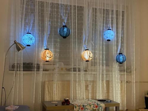 a group of blue lanterns hanging from a window at Slunný byt v Jizerských horách 5 postelí in Tanvald