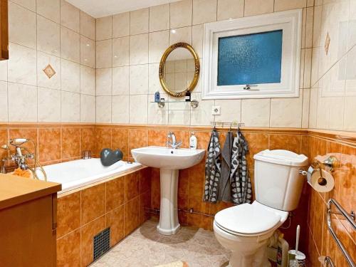 Holiday home STORAHÖGA III في Stora Höga: حمام مع مرحاض ومغسلة وحوض استحمام