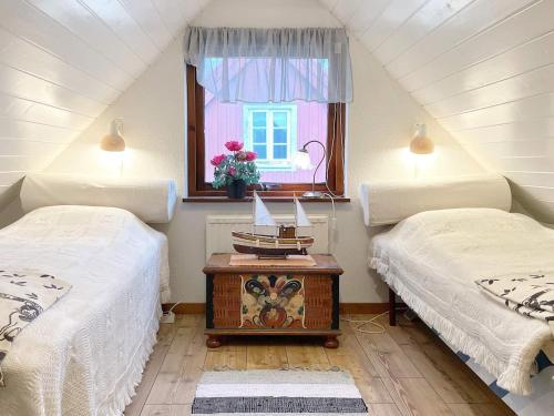 a attic room with two beds and a window at 8 person holiday home in Beddingestrand-By Traum in Beddinge Strand