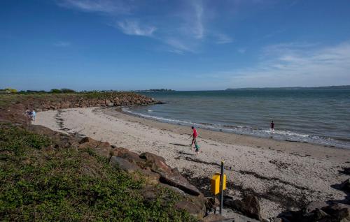 a group of people walking on the beach at Two bedroom townhouse in the heart of Dungarvan in Dungarvan