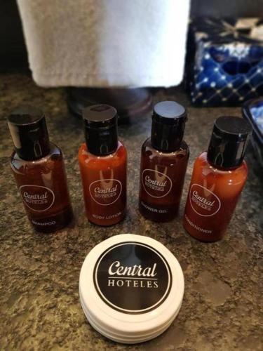 a group of four bottles of condiments on a counter at Historico Central Hotel in Mexico City