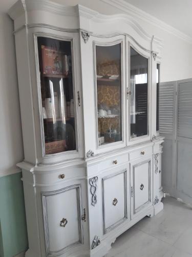 a white hutch with glass doors in a room at B&B Domus Aurea 20 in San Giovanni Teatino