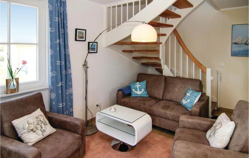 a living room with two chairs and a staircase at Nice Home In Zierow Ot Poeler Drift in Zierow