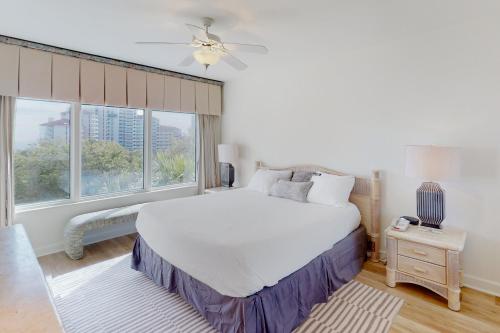 a bedroom with a large white bed and a window at TOPS'L Summit I in Destin