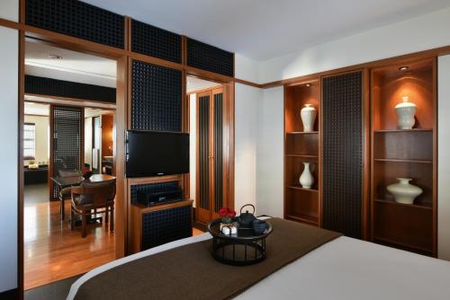 a bedroom with a bed and a living room at The Setai, Miami Beach in Miami Beach