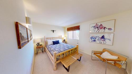 a bedroom with a bed and a chair in it at Steel Bender Retreat #3293 in Moab
