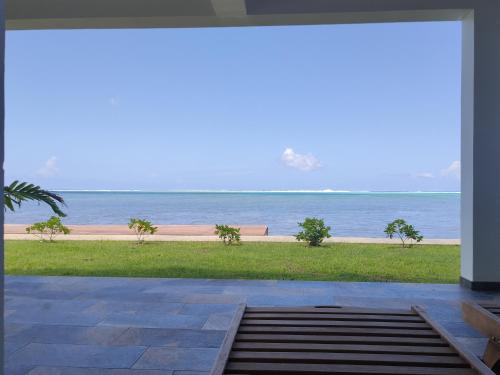 a view of the beach from the porch of a house at Villa MATOANUI in Tevaitoa