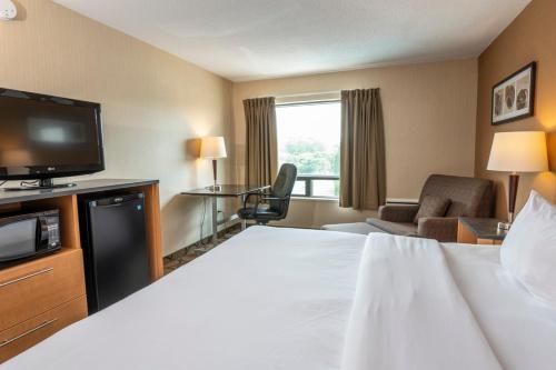 a hotel room with a bed and a flat screen tv at Comfort Inn in Sydney