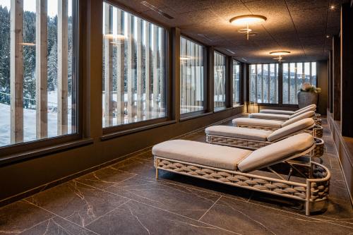 a row of seats in a room with windows at Sporthotel Obereggen in Obereggen