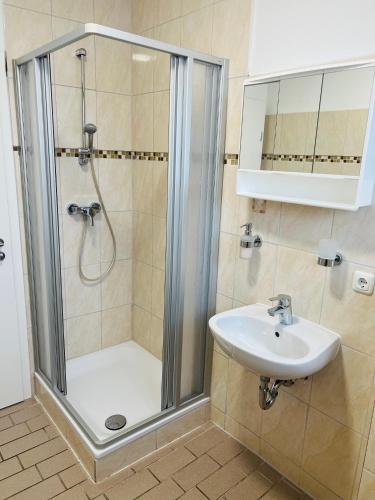 a bathroom with a shower and a sink at M&M Hotel - Wilhelmsburg in Hamburg