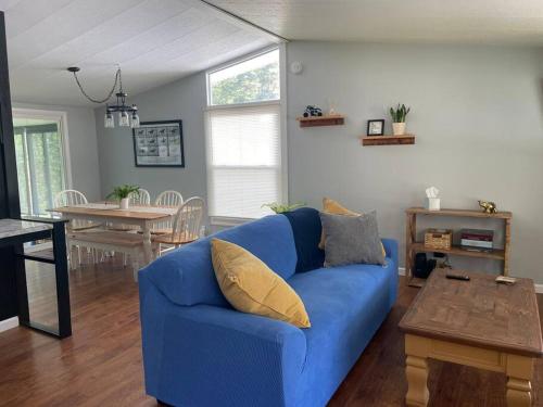 a blue couch in a living room with a table at Bright 3bdrm perfect location 2.5 mi to SPAC , Close to track, downtown and Saratoga hospital in Ballston Spa