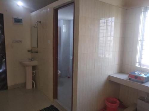 a bathroom with a shower and a toilet and a sink at Secured Family Studio Apartment-near Airport,AC,Fridge,WiFi,Stove in Dhaka