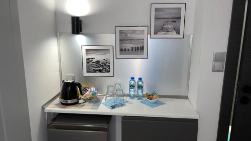 a white counter with drinks and bottles on it at APARTHOTEL in Przemyśl