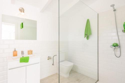 a bathroom with a toilet and a glass shower at Villa Molly 16 by Villa Plus in Punta Prima