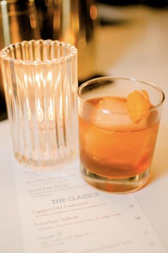 a drink in a glass sitting on top of a table at The Middleton Hotel in Graham