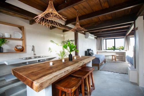 a kitchen with a large wooden counter in a room at Amansala Resort in Tulum