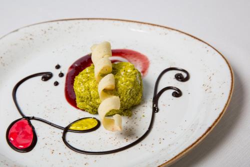 a plate of food with some food on it at Gardaland Hotel in Castelnuovo del Garda