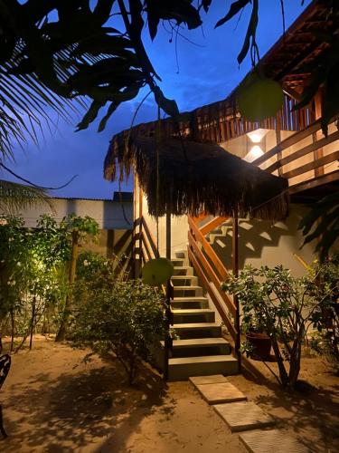 a staircase leading to a house with a building at Pousada Águas de Tamandaré in Tamandaré
