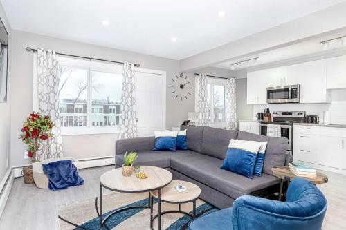 a living room with a couch and a table at Modern & Stylish 1-Bedroom Unit in Edmonton
