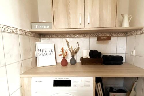 a kitchen with a counter top with a dishwasher at Stilvolles kleines Ferienhaus mit Garten in Willofs