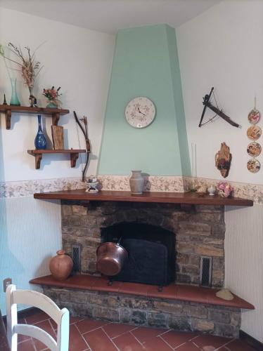 a living room with a brick fireplace with a mantle at Villa Camelia Tuscany in Pescia