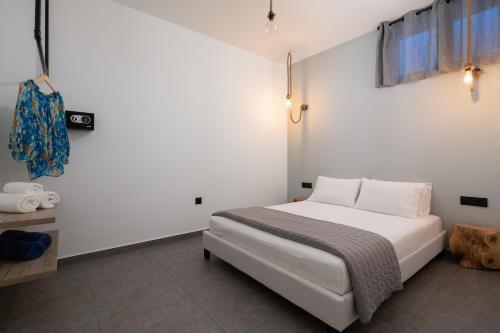 a bedroom with a bed in a white room at Southrock Villas in Lachania