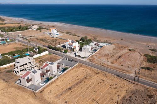 an aerial view of a building next to the ocean at Southrock Villas in Lachania